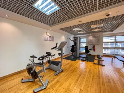 a gym with treadmills and exercise equipment in a building at Cosmos Living Elegant Studio Near Dubai Marina in Dubai