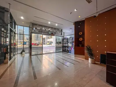 a lobby of a store with a large glass door at Cosmos Living Elegant Studio Near Dubai Marina in Dubai