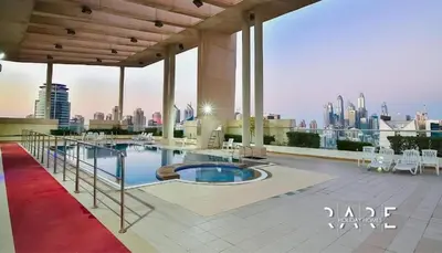a pool on top of a building with a view of the city at White Sage - Lakefront Apartment Amidst Parks With Lake Access in Dubai