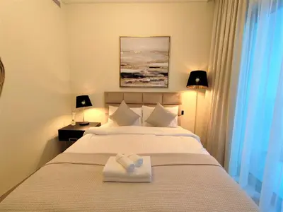 a bedroom with a bed with a towel on it at Modern 1 bedroom - Close to Business Bay - Sobha Creek Vista in Dubai