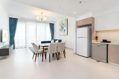 a kitchen and dining room with a table and chairs at Lux BnB The Grand Creek Harbor Views in Dubai
