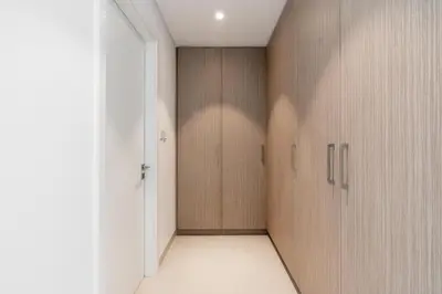 a corridor with wooden doors in a room at Lux BnB The Grand Creek Harbor Views in Dubai