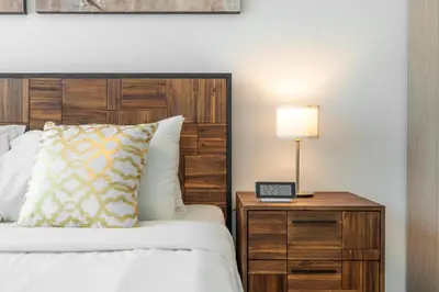 a bedroom with a bed and a night stand with a lamp at Lux BnB The Grand Creek Harbor Views in Dubai