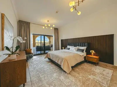 a bedroom with a bed and a desk and a chair at Luton Vacation Homes - Luxury & Spacious 1BR North Residence Fairmont , Palm Jumeirah - 90AB3 in Dubai