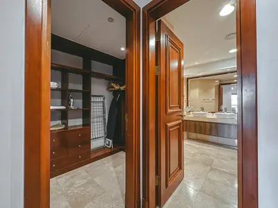 a bathroom with wooden doors and a sink and a mirror at Luton Vacation Homes - Luxury & Spacious 1BR North Residence Fairmont , Palm Jumeirah - 90AB3 in Dubai