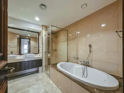 a large bathroom with a tub and two sinks at Luton Vacation Homes - Luxury & Spacious 1BR North Residence Fairmont , Palm Jumeirah - 90AB3 in Dubai