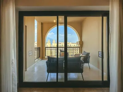 a view of a living room from a balcony at Luton Vacation Homes - Luxury & Spacious 1BR North Residence Fairmont , Palm Jumeirah - 90AB3 in Dubai
