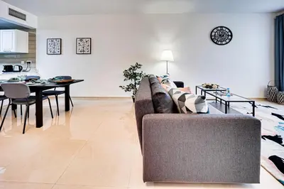 a living room with a couch and a table at Big sea view studio in JBR in Dubai