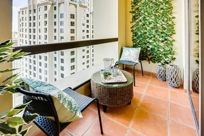 a balcony with a table and chairs on a building at Big sea view studio in JBR in Dubai