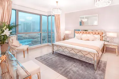 a bedroom with a bed and a large window at Elite Royal Apartment - Full Burj Khalifa & Fountain View - Majesty in Dubai