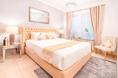 a bedroom with a large bed and a chair at Elite Royal Apartment - Full Burj Khalifa & Fountain View - Majesty in Dubai