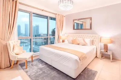 a bedroom with a white bed and a large window at Elite Royal Apartment - Full Burj Khalifa & Fountain View - Majesty in Dubai