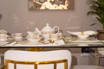 a table with tea cups and saucers on it at Elite Royal Apartment - Full Burj Khalifa & Fountain View - Majesty in Dubai