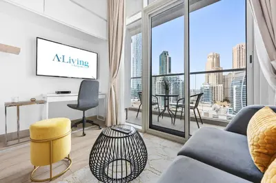 a living room with a couch and a large window at ALiving Cozy Studio with Canal View I Studio One, Dubai Marina in Dubai
