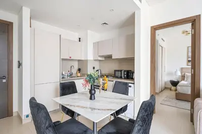a kitchen and dining room with a table and chairs at New 2 bedroom in Meydan - Burj Khalifa View in Dubai