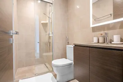 a bathroom with a toilet and a glass shower at New 2 bedroom in Meydan - Burj Khalifa View in Dubai