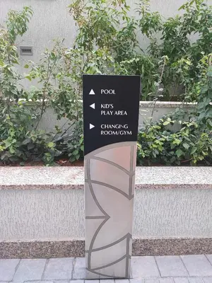a sign on a sidewalk in front of a building at New 2 bedroom in Meydan - Burj Khalifa View in Dubai