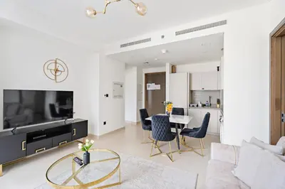 a living room with a large tv and a table at New 2 bedroom in Meydan - Burj Khalifa View in Dubai
