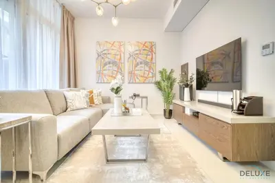 a living room with a couch and a table at Alluring 3BR Townhouse at DAMAC Hills 2, Dubailand by Deluxe Holiday Homes in Dubai
