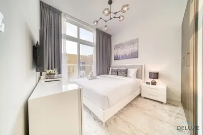 a white bedroom with a bed and a window at Alluring 3BR Townhouse at DAMAC Hills 2, Dubailand by Deluxe Holiday Homes in Dubai