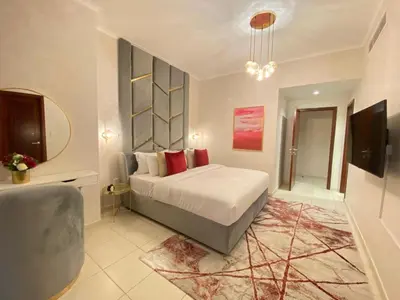 a bedroom with a bed and a television in it at Durrani Homes - The Residences 5BR Besides Dubai Mall with Burjkhalifa and Fountain view in Dubai