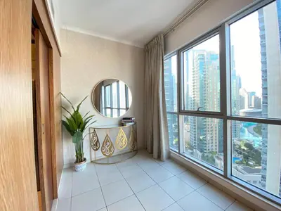 a room with a large window with a table and a mirror at Durrani Homes - The Residences 5BR Besides Dubai Mall with Burjkhalifa and Fountain view in Dubai