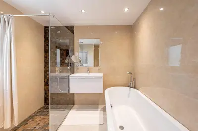 a bathroom with a bath tub and a sink at Deluxe Retreat In JBR - Million Dollar View - Balcony in Dubai