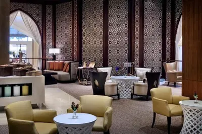 a lobby with chairs and tables in a hotel at Fashion Avenue Dubai Mall Highest Floor Burj Khalifa View Residence- Formerly Address Dubai Mall in Dubai