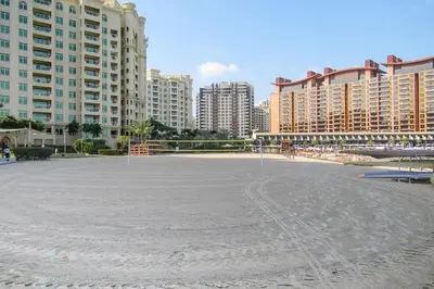 a large empty beach in front of some tall buildings at Frank Porter - Al Nabat in Dubai