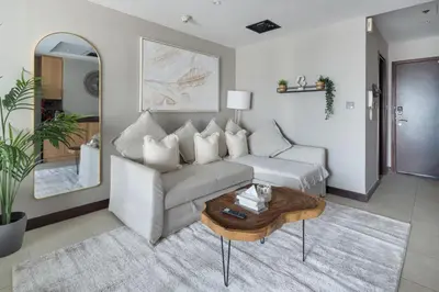 a living room with a couch and a table at Chic JLT Studio, Lake View, Pool, Metro Access in Dubai