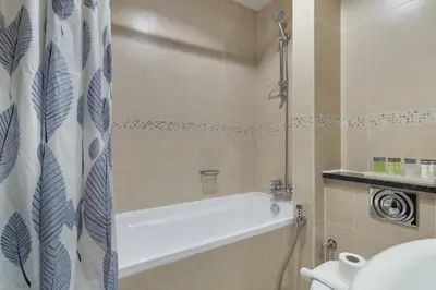 a bathroom with a bath tub and a toilet at Chic JLT Studio, Lake View, Pool, Metro Access in Dubai
