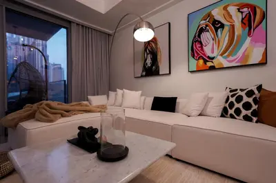 a living room with a white couch and a table at Majestay - Luxury Living in Dubai