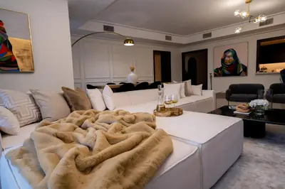 a living room with a white couch with a blanket at Majestay - Luxury Living in Dubai