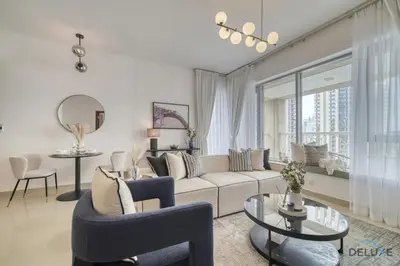 a living room with a couch and a table at Harmonious 1BR at 29 BLVD Tower 1 Downtown Dubai by Deluxe Holiday Homes in Dubai