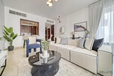a living room with a couch and a table at Harmonious 1BR at 29 BLVD Tower 1 Downtown Dubai by Deluxe Holiday Homes in Dubai