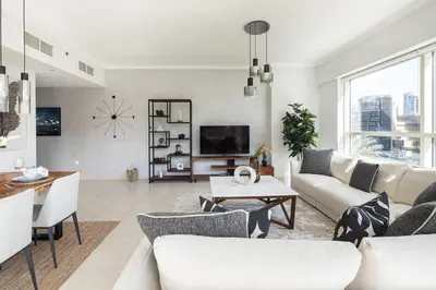 a living room with a couch and a table at Frank Porter - Al Sahab 2 in Dubai