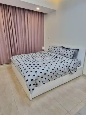 a bedroom with a bed with a black and white comforter at Premium Lovely Studio with Balcony in Dubai in Dubai