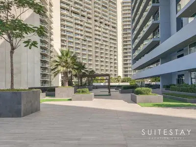 a courtyard in front of a large building at Prestigious Studio With High Quality Interiors in Dubai