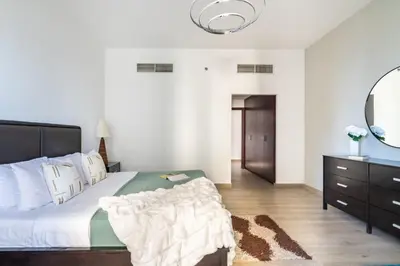a bedroom with a large bed and a mirror at The Smart Concierge - Amwaj 4 in Dubai