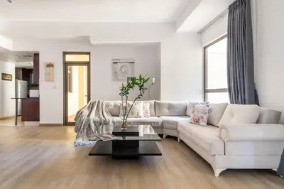 a living room with a white couch and a table at The Smart Concierge - Amwaj 4 in Dubai