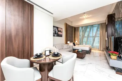 a living room with a table and chairs and a couch at SIMPLY COMFORT in J ONE Tower in Dubai