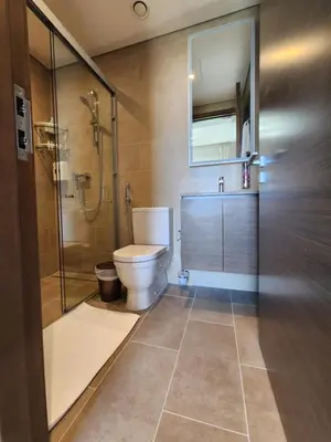 a bathroom with a toilet and a glass shower at STAY BY LATINEM Luxury 2BR Holiday Home CV B1614 near Burj Khalifa in Dubai