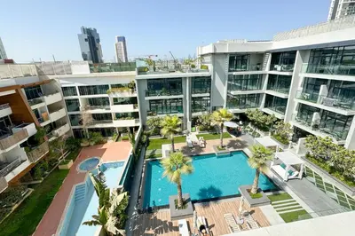 an aerial view of an apartment complex with a swimming pool at Mesmerizing nicely furnished studio in JVC in Dubai