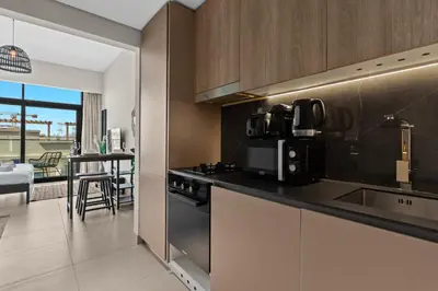 a kitchen with a sink and a counter top at Mesmerizing nicely furnished studio in JVC in Dubai
