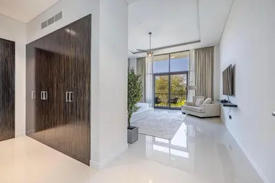 a living room with a wooden door and a couch at Daniels Golf Course 5BR Villa with Private Pool in Dubai