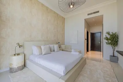 a bedroom with a large white bed in a room at Daniels Golf Course 5BR Villa with Private Pool in Dubai