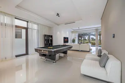 a large living room with a pool table in it at Daniels Golf Course 5BR Villa with Private Pool in Dubai