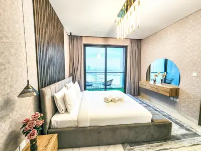 a bedroom with a bed and a large window at STAY BY LATINEM Luxury 1 BR Holiday Home OPA 1601 near Burj Khalifa in Dubai