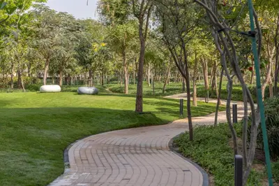 a brick path in a park with trees at STAY BY LATINEM Luxury 1 BR Holiday Home OPA 1601 near Burj Khalifa in Dubai