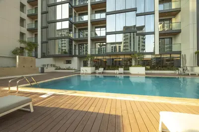 a swimming pool in front of a building at STAY BY LATINEM Luxury 1 BR Holiday Home OPA 1601 near Burj Khalifa in Dubai